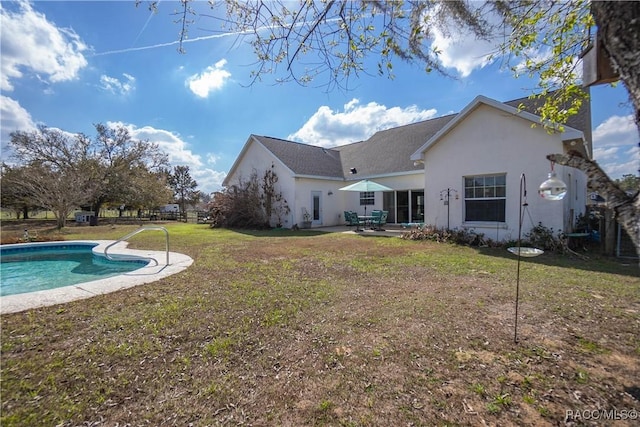 back of house featuring a patio and a lawn