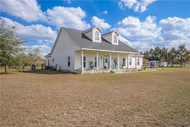 view of front of property with covered porch and a front yard