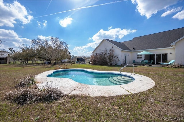 view of swimming pool featuring a yard and a patio area