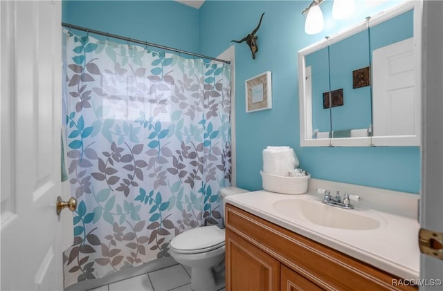 bathroom with vanity, tile patterned floors, and toilet