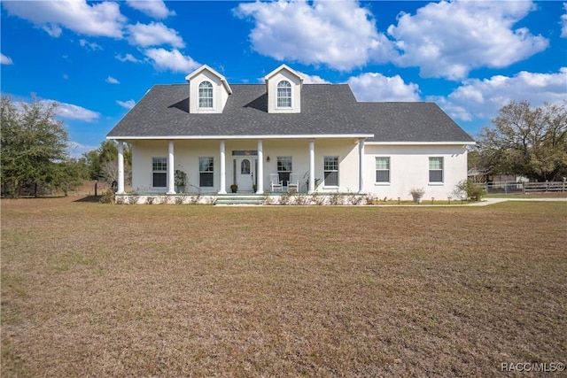 view of front of house featuring covered porch and a front yard