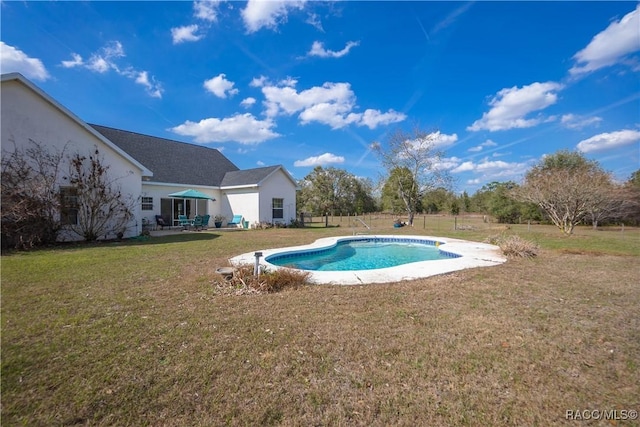 view of pool featuring a yard and a patio