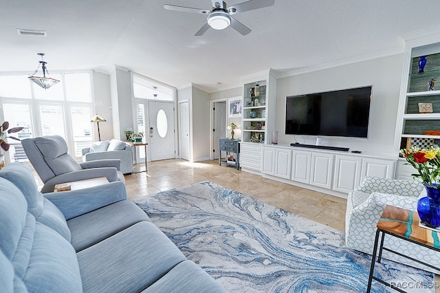 living room featuring a textured ceiling, ceiling fan, built in features, and ornamental molding