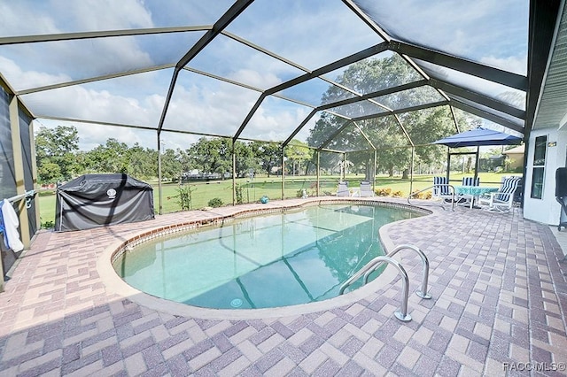 view of swimming pool with a patio, a lanai, and area for grilling