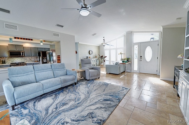 living room with lofted ceiling, ceiling fan, and crown molding