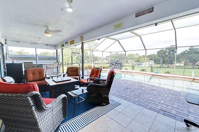 view of patio featuring ceiling fan, an outdoor living space with a fire pit, and glass enclosure