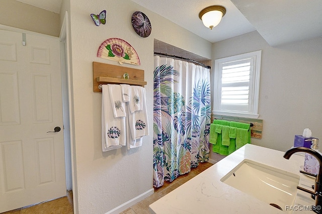 bathroom featuring a shower with curtain and vanity