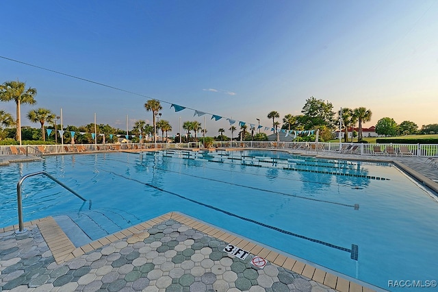 view of pool at dusk