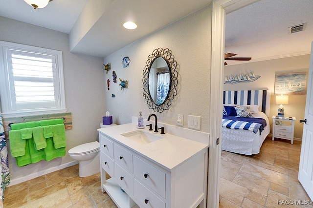 bathroom featuring ceiling fan, vanity, and toilet