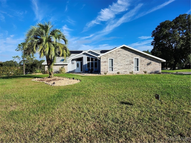 rear view of property featuring a yard