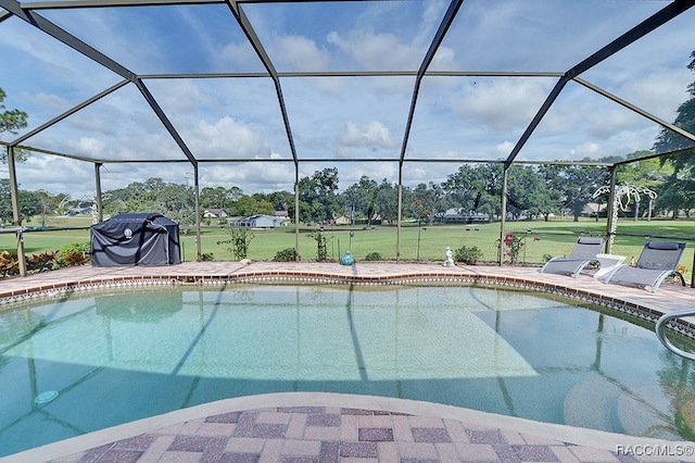 view of pool featuring a lanai, a patio area, and a yard