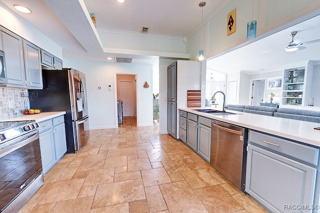 kitchen featuring backsplash, gray cabinetry, sink, and stainless steel appliances