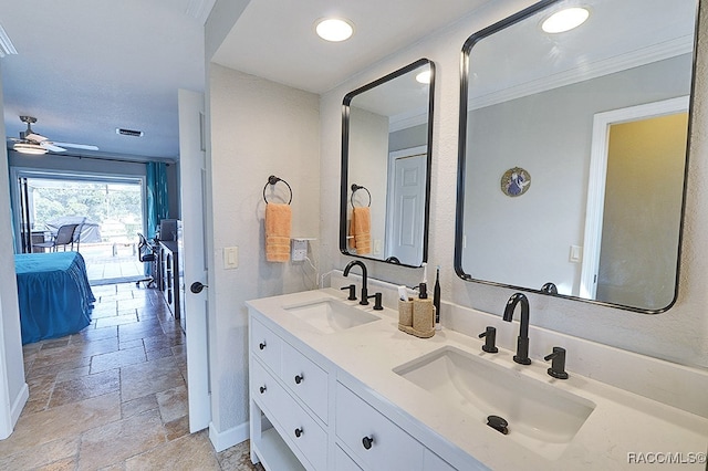 bathroom with ceiling fan, ornamental molding, and vanity