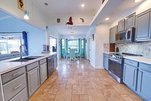 kitchen with sink, hanging light fixtures, stainless steel appliances, backsplash, and crown molding