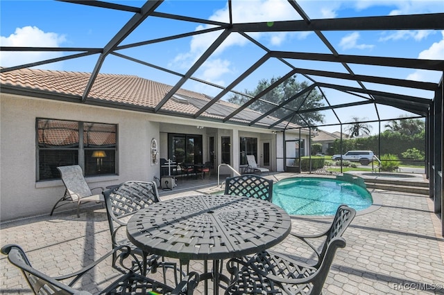 view of pool with a patio area and a lanai