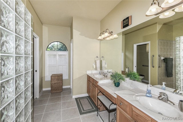 bathroom with vanity, vaulted ceiling, tile patterned flooring, a shower with shower door, and a chandelier