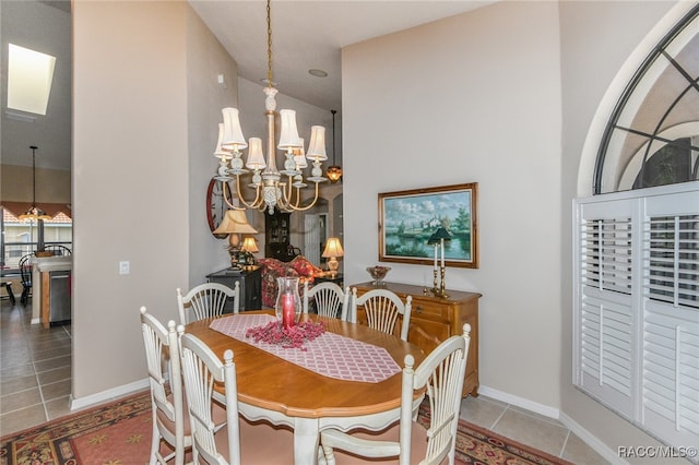 tiled dining area with a chandelier