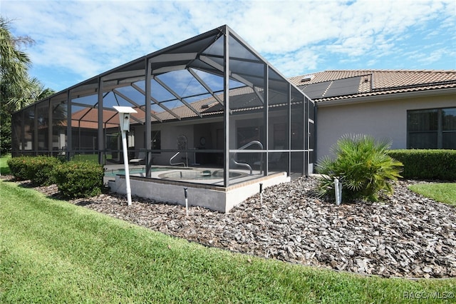 back of house with glass enclosure