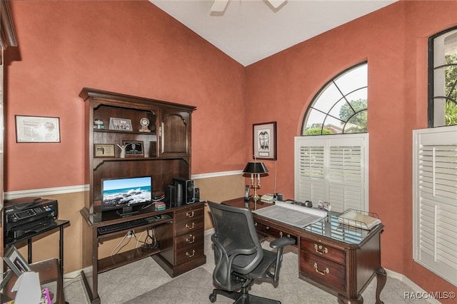 carpeted office featuring ceiling fan