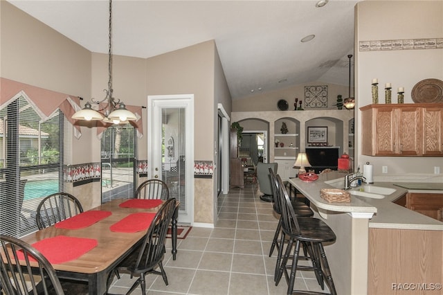 interior space featuring sink, light tile patterned flooring, a chandelier, and vaulted ceiling