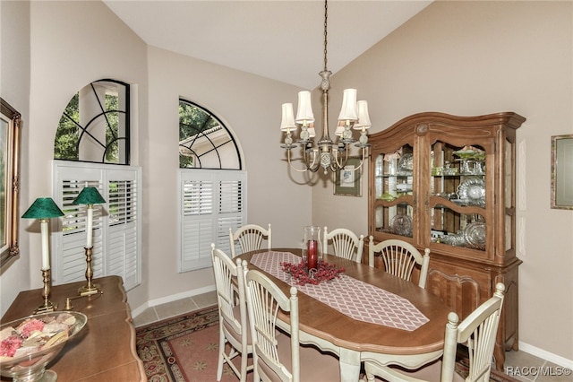 tiled dining area featuring lofted ceiling and a notable chandelier