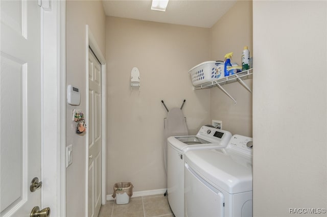 laundry room featuring light tile patterned flooring and independent washer and dryer