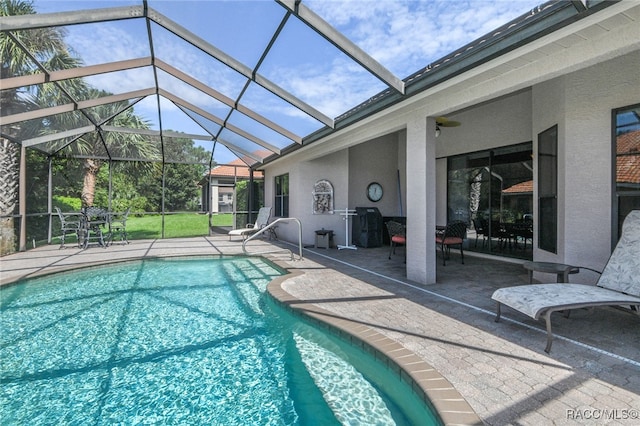 view of pool with a lanai and a patio