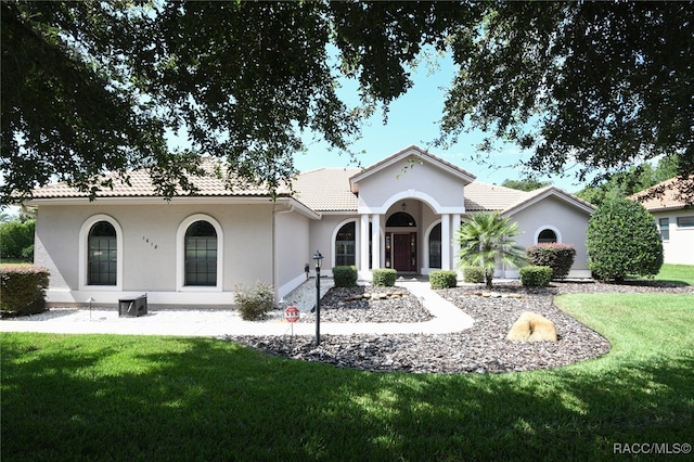 mediterranean / spanish house with a front yard