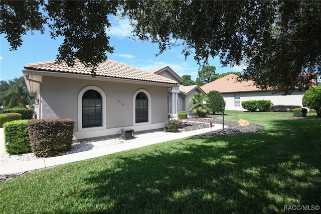 rear view of property with a lawn