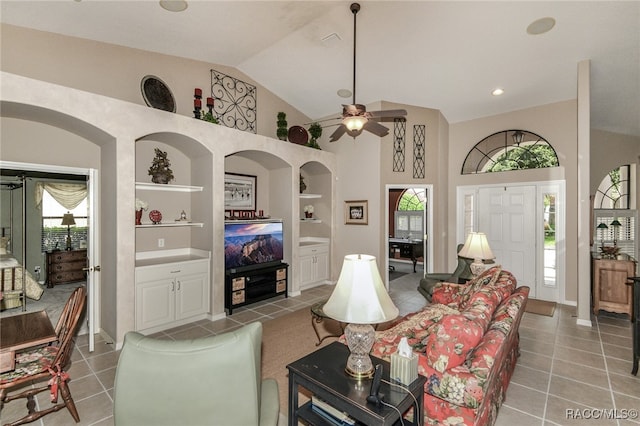 living room with tile patterned floors, ceiling fan, built in features, and vaulted ceiling