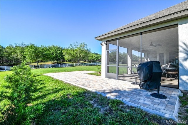 view of patio with area for grilling and a sunroom