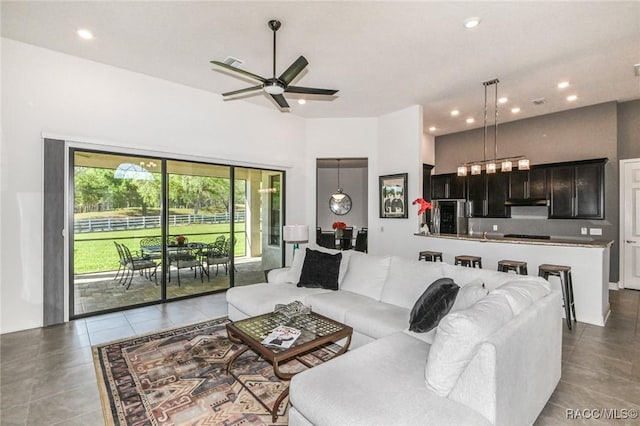 tiled living room featuring ceiling fan