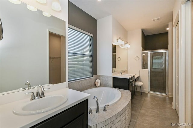 bathroom featuring tile patterned flooring, vanity, and separate shower and tub