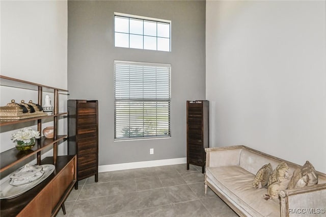 living area with tile patterned floors