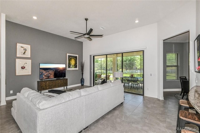 tiled living room featuring ceiling fan