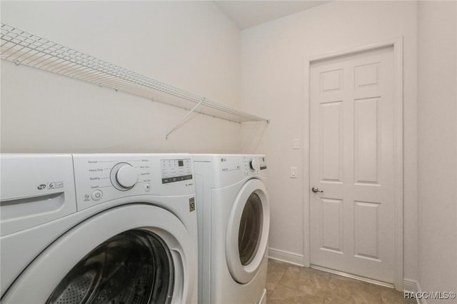 washroom featuring light tile patterned floors and washing machine and clothes dryer