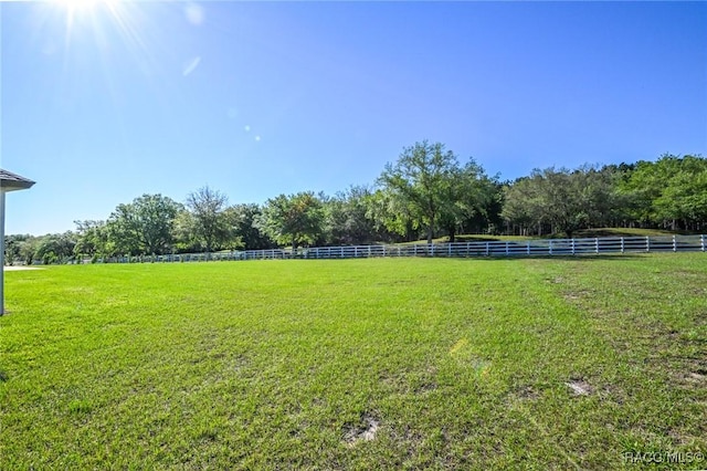 view of yard with a rural view