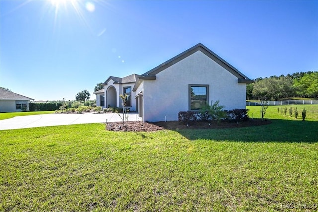 view of side of home with a yard and a garage