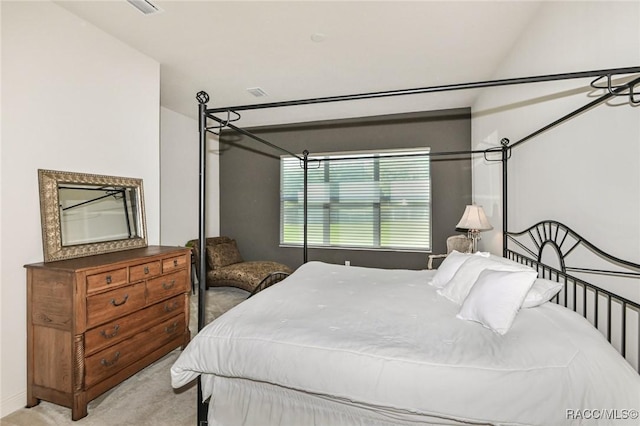 carpeted bedroom featuring vaulted ceiling