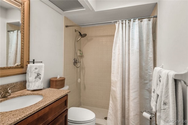 bathroom featuring vanity, toilet, and a shower with shower curtain