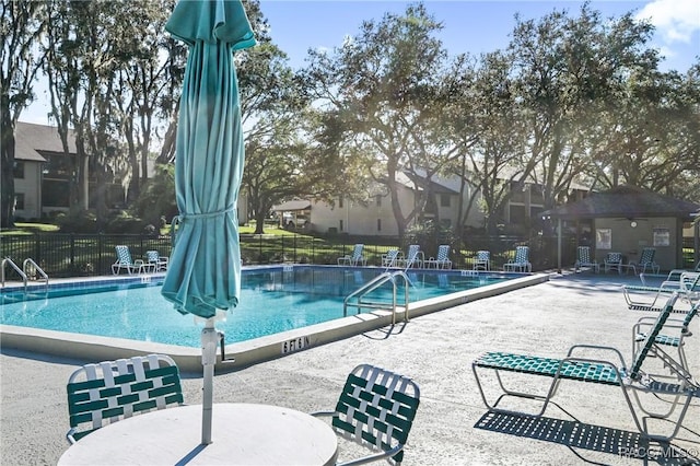 view of swimming pool with a patio area