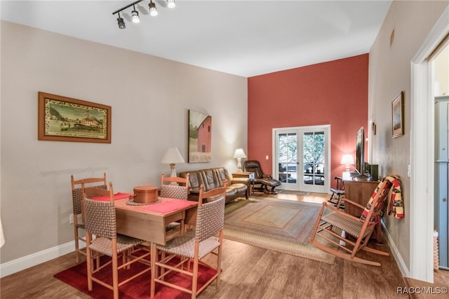 dining area with track lighting and hardwood / wood-style floors