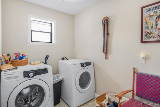 laundry room with washing machine and clothes dryer and light tile patterned floors