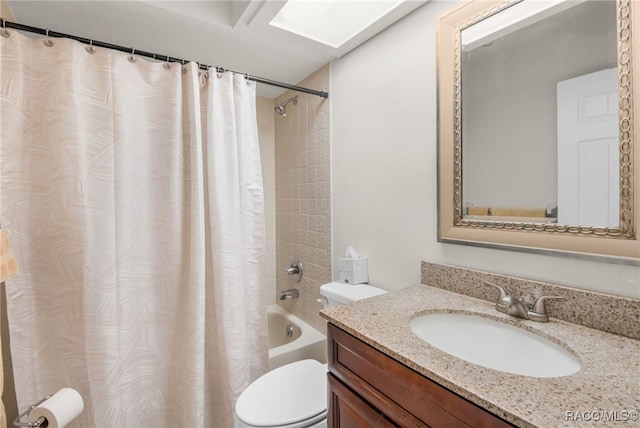 full bathroom with vanity, a skylight, toilet, and shower / tub combo with curtain