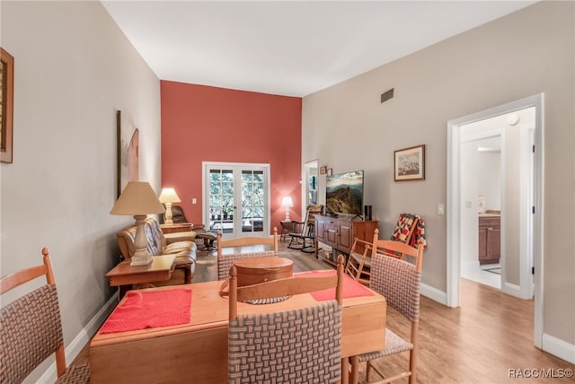 dining space featuring light hardwood / wood-style floors and french doors