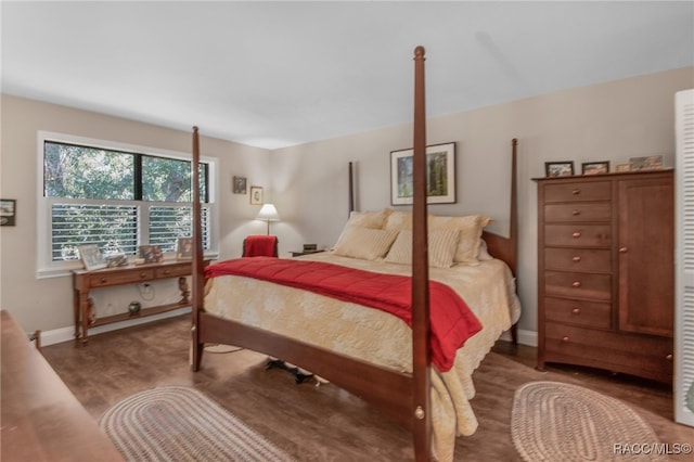 bedroom with dark wood-type flooring