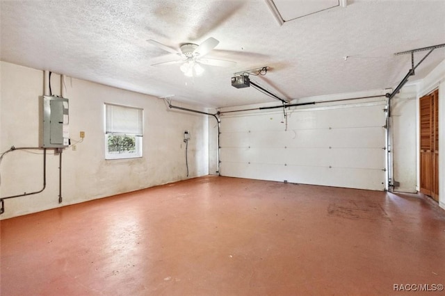 garage with a garage door opener, electric panel, and a ceiling fan