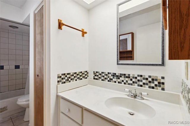 full bathroom featuring decorative backsplash, vanity, toilet, and tile patterned floors