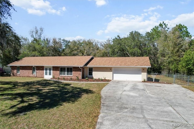 single story home featuring a front yard, fence, driveway, and an attached garage