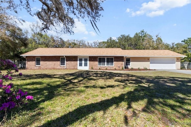 ranch-style house featuring a garage, brick siding, fence, and a front lawn